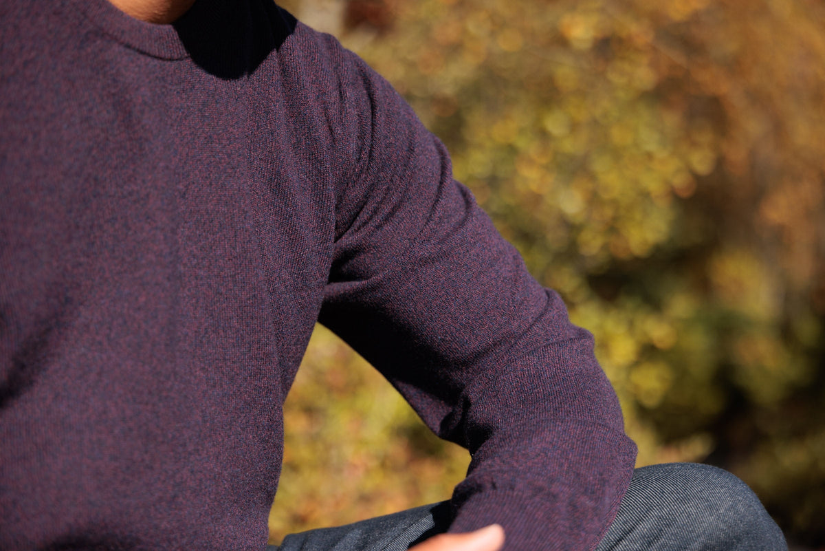 The Earnest 2-ply cashmere crewneck in Heather Plum, sleeve bent at the elbow