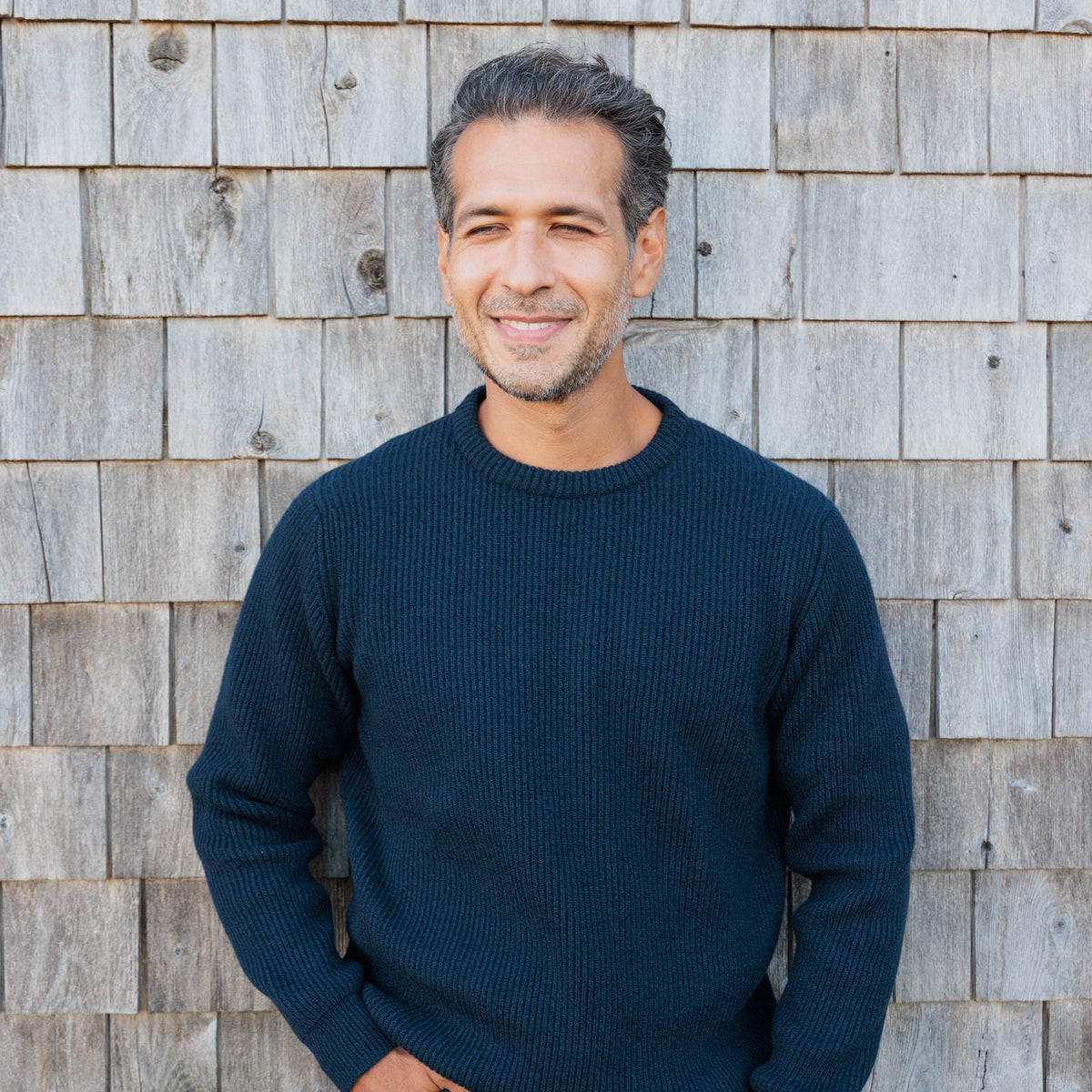 The Finlay 4-ply Scottish cashmere ribbed crewneck in Midnight, by the shingle wall