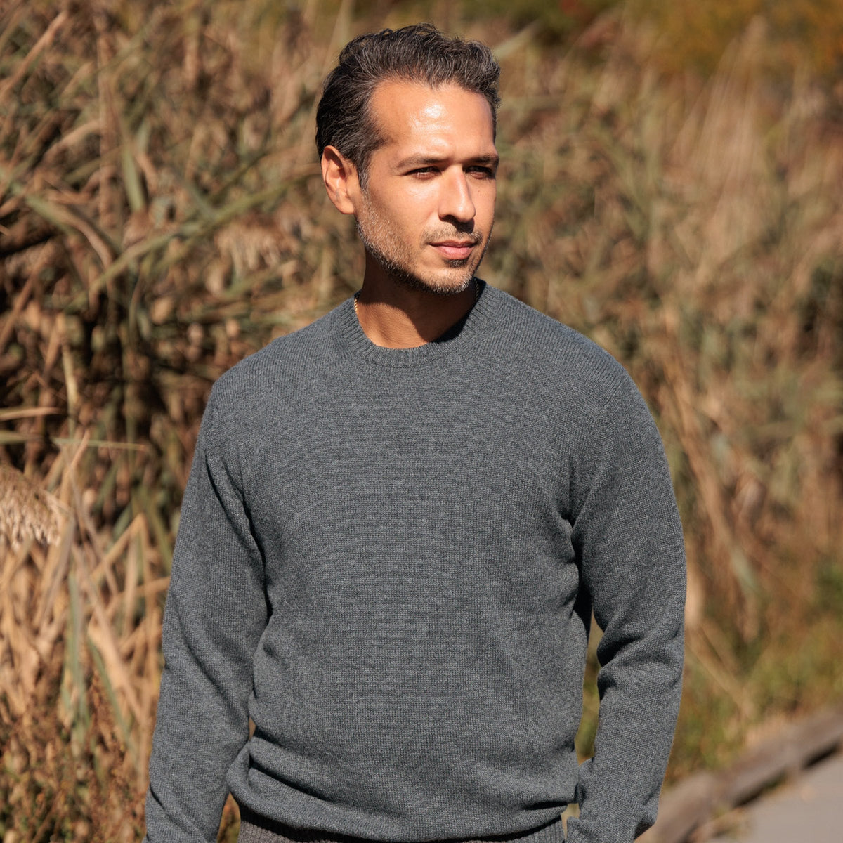 The Fraser 4-ply Scottish cashmere relaxed crewneck in Derby Grey, walking in the reeds