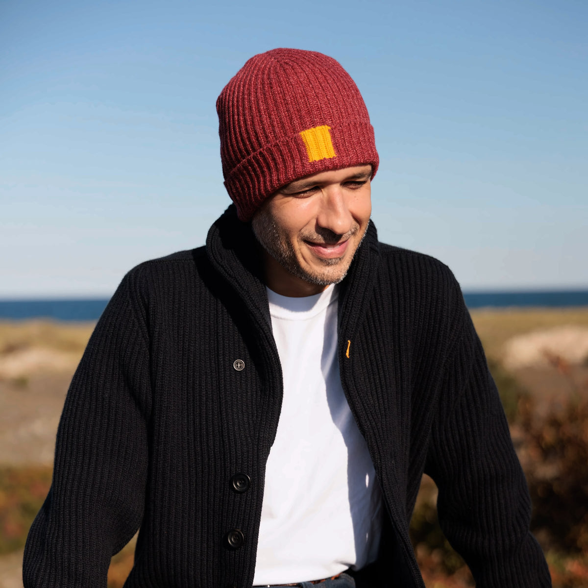 The George 8-ply Scottish cashmere beanie in Rowan, styled with a cardigan