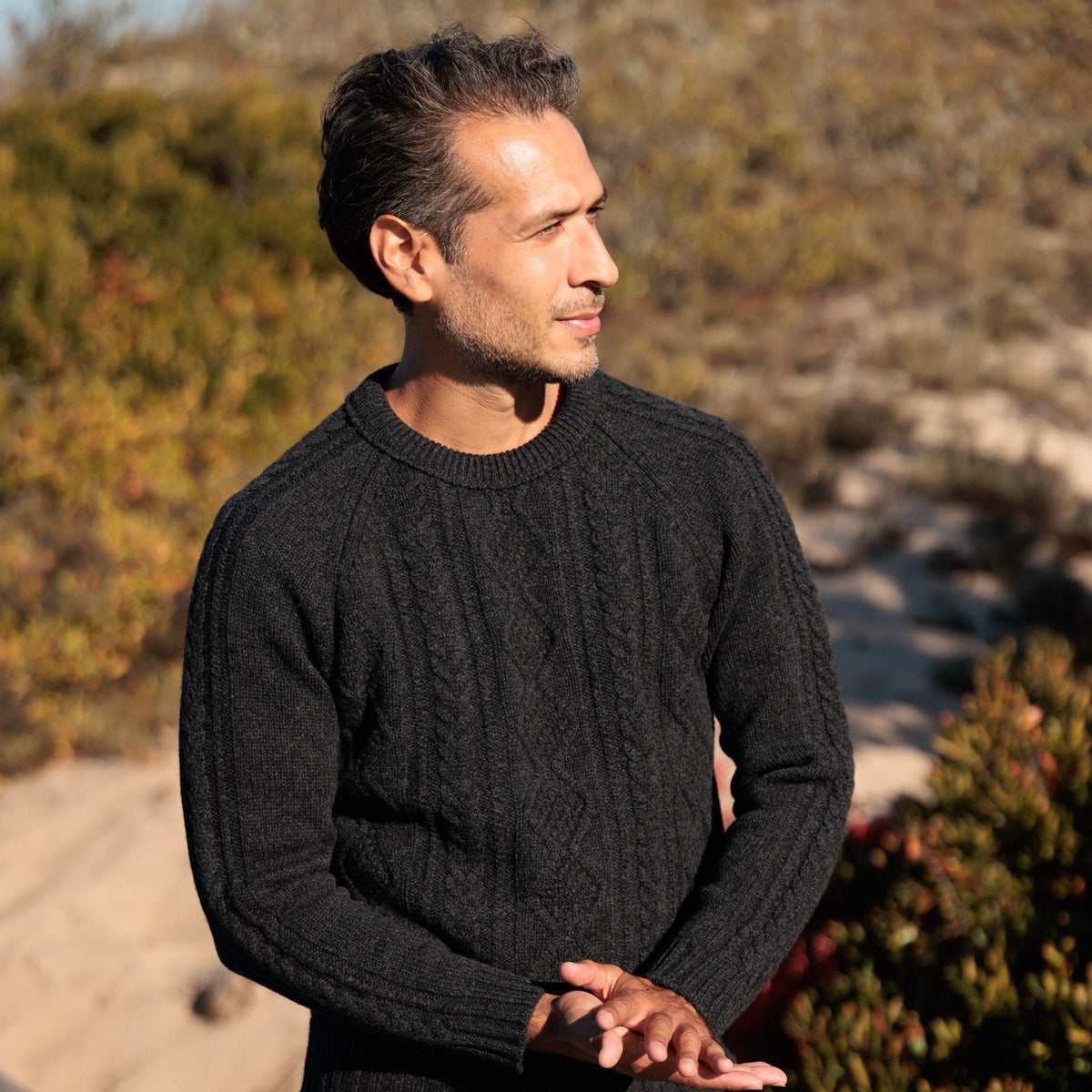 The Ross 4-ply Scottish lambswool cable knit crewneck in Charcoal, three-quarter view showing the sleeve cable